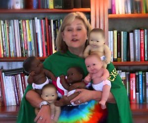 Dr. Bailey holding baby dolls doing Baby Doll Circle Time